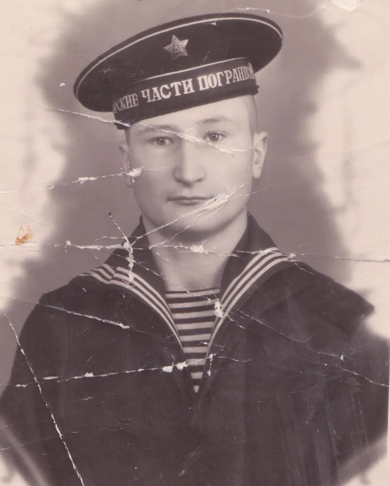 Old original photo before AI restoration — Heavy cracks and scratches across the entire photo — fully removed with face and uniform detail restored